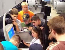 Students gathered around a jet simulator.